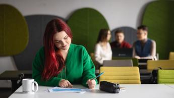 Zarządzanie produkcją | Studia I stopnia w Chorzowie | Uniwersytet WSB Merito Chorzów: studentka analizuje tabelę danych na zajęciach