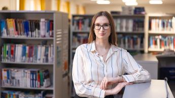 Menedżer produkcji i Lean Manufacturing | Studia II stopnia w Chorzowie | Uniwersytet WSB Merito Chorzów: Studentka stojąca w bibliotece
