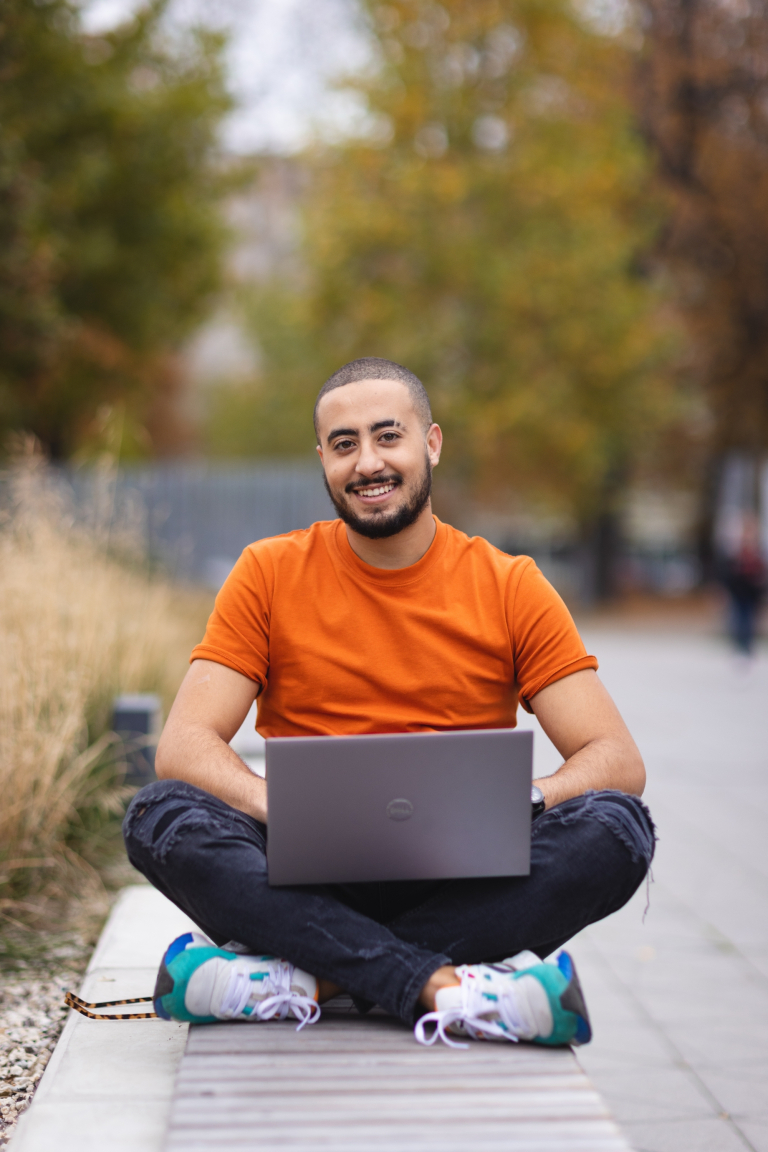 Admissions process stages | WSB Merito Poznań University: Student with a laptop