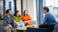 Finanse i rachunkowość | Studia II stopnia ze studiami podyplomowymi w Gdańsku | Uniwersytet WSB Merito w Gdańsku: Studenci siedzą w holu i rozmawiają siedząc na kanapach