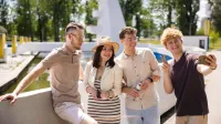 Rozwój produktów w małej firmie | Studia podyplomowe w Gdyni | Uniwersytet WSB Merito Gdynia: grupa znajomych stoi przy fontannie i robi selfie