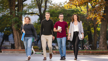 Bezpieczeństwo i higiena pracy | Uniwersytet WSB Merito Łódź: 4 studentów Uniwersytetu WSB Merito w Łodzi w wesołej atmosferze idzie przez park