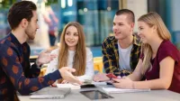 Coaching, mentoring i facylitacja | Studia I stopnia w Warszawie | Uniwersytet WSB Merito Warszawa: Grupa studentów przy notatkach