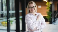 Pentester - specjalista ds. cyberbezpieczeństwa | Studia podyplomowe w Warszawie | Uniwersytet WSB Merito Warszawa: uśmiechnięta kobieta w koszuli