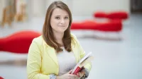 Edukacja i terapia osób z zaburzeniami ze spektrum autyzmu | Studia podyplomowe w Warszawie | Uniwersytet WSB Merito Warszawa: kobieta trzymająca książkę