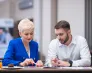 Poznaj nas | Uniwersytet WSB Merito Warszawa: Student i wykładowca rozmawiają o projekcie.